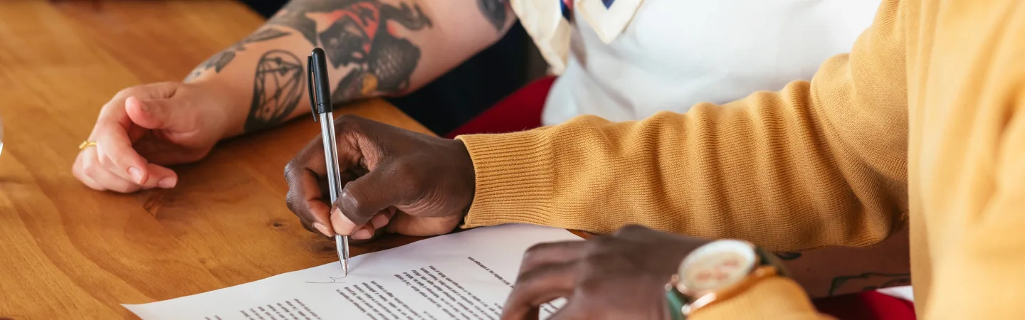 Close up of the hands of a lawyer and client going through paperwork